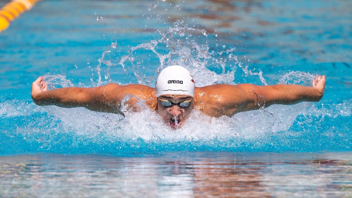 ASU swimmer Ilya Kharun swimming in a pool.