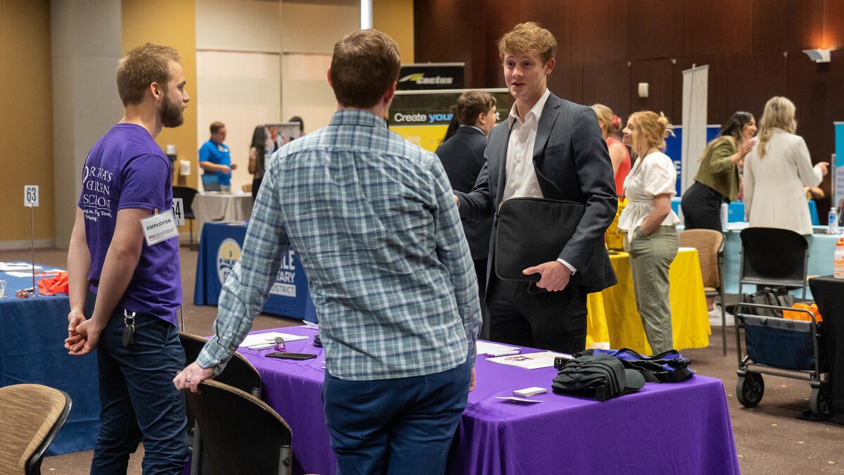 Students talking at a booth at an ASU Career Fair